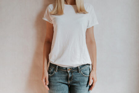 Blond Hair Woman Posing Near A Light Wall. Beautiful Young Cauca